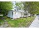 Charming home boasts mature trees, side porch, and well-maintained landscaping, offering great curb appeal at 307 E 5Th St, Sheridan, IN 46069