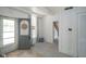 Charming foyer with a decorated door, a window, and light-colored carpeting, provides a welcoming entrance to the home at 307 E 5Th St, Sheridan, IN 46069