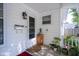 Charming front porch featuring a white door, potted plants, and a well-lit entryway at 307 E 5Th St, Sheridan, IN 46069