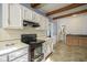 Well-lit kitchen with white cabinets, modern appliances, and tiled floors create a functional space for culinary creations at 307 E 5Th St, Sheridan, IN 46069