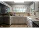 Bright vintage kitchen with white cabinets, countertops, and tiled floors is perfect for cooking and meal preparation at 307 E 5Th St, Sheridan, IN 46069