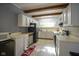 Vintage kitchen with white cabinets, a stainless-steel refrigerator, and an eating area blends function and charm at 307 E 5Th St, Sheridan, IN 46069