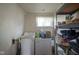Functional laundry room featuring a washer, dryer, storage shelves and a window for natural light at 307 E 5Th St, Sheridan, IN 46069