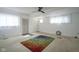 Inviting living room featuring a ceiling fan, carpet, bright light, and a colorful rug at 307 E 5Th St, Sheridan, IN 46069