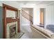 Inviting living room with a decorative fireplace, adjacent to a carpeted stairway, offers a cozy atmosphere at 307 E 5Th St, Sheridan, IN 46069