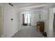 Open-concept living area with white walls, carpeting, and vintage piano allows for relaxation and entertainment at 307 E 5Th St, Sheridan, IN 46069