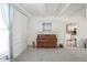 Sun-filled room with an antique piano, white walls and ceilings, and neutral carpeting provide a spacious atmosphere at 307 E 5Th St, Sheridan, IN 46069
