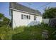 Exterior view of the shed with a small window and white door and horizontal siding at 307 E 5Th St, Sheridan, IN 46069