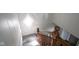 Bright stairway with wood railing, a window, and neutral carpeting offers a warm welcome to this cozy home at 307 E 5Th St, Sheridan, IN 46069