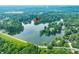 An aerial view of a stunning lakeside property with lush trees, and a tranquil lake at 3695 Windsor Pl, Martinsville, IN 46151