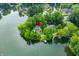 Picturesque aerial view of an island home on a lake, surrounded by lush greenery and serene waters at 3695 Windsor Pl, Martinsville, IN 46151