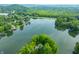 Scenic aerial view of a lake community surrounded by lush green trees and rolling hills at 3695 Windsor Pl, Martinsville, IN 46151
