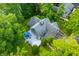 Aerial view of a house showcasing its unique roof design and an outdoor patio with a blue umbrella at 3695 Windsor Pl, Martinsville, IN 46151
