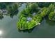 Aerial view of waterfront property and neighborhood outlined in white on a wooded lot at 3695 Windsor Pl, Martinsville, IN 46151