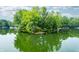 Beautiful aerial view of a waterfront home surrounded by lush trees and still, blue water at 3695 Windsor Pl, Martinsville, IN 46151