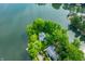 Aerial view of waterfront home surrounded by lush trees with boat dock at 3695 Windsor Pl, Martinsville, IN 46151