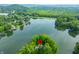 Aerial view of a lakeside home surrounded by lush greenery and serene lake waters at 3695 Windsor Pl, Martinsville, IN 46151