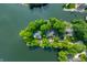 Stunning aerial view of waterfront homes surrounded by lush greenery on a private peninsula at 3695 Windsor Pl, Martinsville, IN 46151
