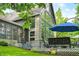 A charming home exterior featuring a spacious patio with seating and a view of the well-manicured lawn at 3695 Windsor Pl, Martinsville, IN 46151