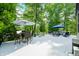 Spacious outdoor deck area featuring dining and seating arrangements and lush trees at 3695 Windsor Pl, Martinsville, IN 46151