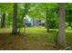 Secluded backyard view of a house, featuring mature trees and outdoor lounge areas at 3695 Windsor Pl, Martinsville, IN 46151