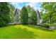Beautifully landscaped backyard featuring lush green lawn, mature trees, and a charming deck for outdoor relaxation at 3695 Windsor Pl, Martinsville, IN 46151