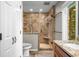 Stunning bathroom with a walk-in shower, gorgeous tile surround, and a wood vanity with stone countertop at 3695 Windsor Pl, Martinsville, IN 46151
