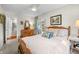 Bright bedroom with a wooden bed frame, dresser, and access to an outdoor patio at 3695 Windsor Pl, Martinsville, IN 46151