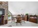 Cozy dining area featuring wood furniture, stone accent wall, and bright natural light from the nearby windows at 3695 Windsor Pl, Martinsville, IN 46151