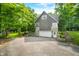 Charming two-story home with gray siding, stone accents, an attached garage, and mature trees at 3695 Windsor Pl, Martinsville, IN 46151