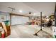 Spacious two-car garage with overhead door, shelving, and ample storage space at 3695 Windsor Pl, Martinsville, IN 46151