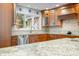 Well-lit kitchen boasting granite counters, wood cabinets and stainless steel appliances at 3695 Windsor Pl, Martinsville, IN 46151