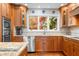 Cozy kitchen with wooden cabinets, stainless steel appliances, granite counters and window views at 3695 Windsor Pl, Martinsville, IN 46151
