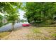 Picturesque lakeside view featuring a gravel bank with a pair of red paddle boats near a charming house at 3695 Windsor Pl, Martinsville, IN 46151