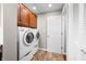 Convenient laundry room with stacked washer and dryer, and overhead storage cabinets at 3695 Windsor Pl, Martinsville, IN 46151