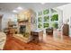 Open living room features stone fireplace, wood floors and a wall of windows at 3695 Windsor Pl, Martinsville, IN 46151