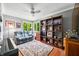 Cozy living room with a comfortable couch, a bookcase filled with books, and bright windows bringing the outdoors inside at 3695 Windsor Pl, Martinsville, IN 46151
