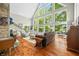 Bright living room features large windows, wood floors, a stone fireplace and comfortable seating at 3695 Windsor Pl, Martinsville, IN 46151