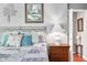 Comfortable main bedroom features a wrought iron bed frame, warm lighting, and an ensuite bath beyond the open door at 3695 Windsor Pl, Martinsville, IN 46151