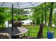 Outdoor dining with wicker furniture overlooking a lush yard with views of the lake at 3695 Windsor Pl, Martinsville, IN 46151