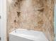Nicely tiled shower and tub featuring a rain shower head and built-in shelves at 3695 Windsor Pl, Martinsville, IN 46151