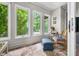 Bright sun room with large windows offering lovely views of the outdoors and a rocking chair with an ottoman at 3695 Windsor Pl, Martinsville, IN 46151