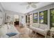 Cozy sunroom with lake views, ceiling fan, and comfortable seating area at 3695 Windsor Pl, Martinsville, IN 46151