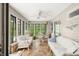 Bright sunroom with lots of windows, ceiling fan, and comfortable seating area at 3695 Windsor Pl, Martinsville, IN 46151