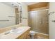 Bathroom featuring a vanity with a sink, a toilet, and a tiled shower with glass doors at 3714 Timberview Ct, Anderson, IN 46011