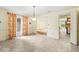 Dining room featuring grey flooring, a chandelier, and decorative curtains at 3714 Timberview Ct, Anderson, IN 46011