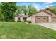 Beautifully maintained brick home with attached garage, complemented by a lush green lawn and mature trees at 3714 Timberview Ct, Anderson, IN 46011