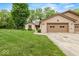Charming brick home featuring an attached two car garage and a well maintained lawn with mature trees at 3714 Timberview Ct, Anderson, IN 46011