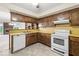 Kitchen features wooden cabinets, laminate countertops, and white appliances at 3714 Timberview Ct, Anderson, IN 46011
