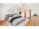 Relaxing bedroom with a ceiling fan, hardwood floors, and modern decor with neutral color palette at 4291 Washington Blvd, Plainfield, IN 46168
